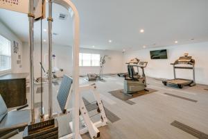 a gym with treadmills and machines in a room at Charming Dallas Apt with Fireplace and Pool Access! in Dallas
