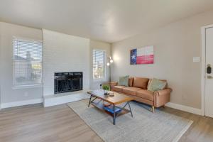 a living room with a couch and a table at Convenient Grand Prairie Apartment with Balcony in Grand Prairie