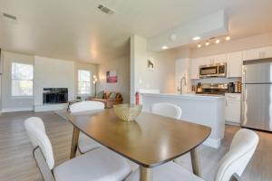 a kitchen and dining room with a table and chairs at Convenient Grand Prairie Apartment with Balcony in Grand Prairie