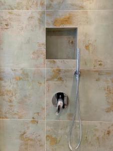 a shower in a bathroom with a mirror at Hotel Locanda Alla Perla in Ledro