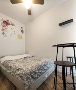 a bedroom with a bed with a table and two stools at welcome to airbnb in Saint-Jean-sur-Richelieu