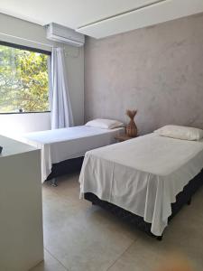 Cama ou camas em um quarto em Casatua Pousada
