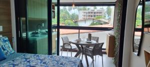 a room with a balcony with a table and chairs at Rooftop103-Tamandaré in Tamandaré