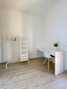 a white desk and a chair in a room at Dimora La Coccinella - Accommodation in Muravera