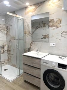 a bathroom with a sink and a washing machine at Relax apartamento 7 in Las Palmas de Gran Canaria