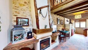 a living room with a fireplace in a house at Casa Rural La Fuente del Fresno in Caballar