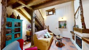 a living room with a couch and a table at Casa Rural La Fuente del Fresno in Caballar