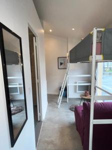 a room with two bunk beds and a mirror at studio bocagère in Amblainville