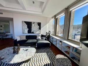 a living room with a couch and a table at #1905 Cartwright - The Spitfire in Cape Town