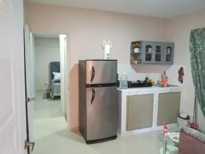 a kitchen with a stainless steel refrigerator in a room at Villa rozenuda in El Higo
