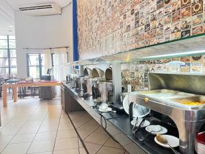 a restaurant kitchen with a line of food at Flat 2313 - Crystal Place in Goiânia