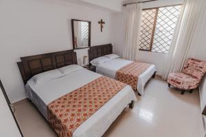 Postel nebo postele na pokoji v ubytování Casa Hotel Miriam