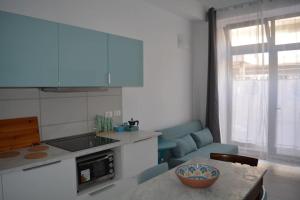a kitchen with a table with a bowl on the table at Casa Ortensia in Santa Teresa di Riva