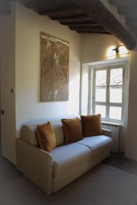 a couch sitting in a room with a window at La Mansardina Beccheria Central Apartment 1 double bedroom, 1 sofa bed in Lucca