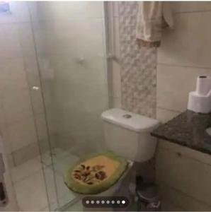 a bathroom with a toilet and a glass shower at Casa completa em união da vitória PR in União da Vitória