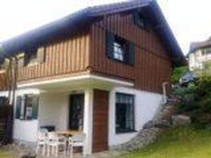 a large house with a table in front of it at Ferienhaus Alpkönigin in Missen mit Garten und Terrasse in Missen-Wilhams