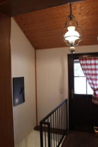 a hallway with a door and a window and a chandelier at Ferienhaus Alpkönigin in Missen mit Garten und Terrasse in Missen-Wilhams