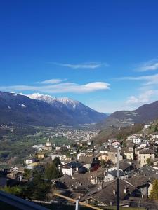 a city with snow covered mountains in the background at B&B LA SPINA 2 in Poggiridenti