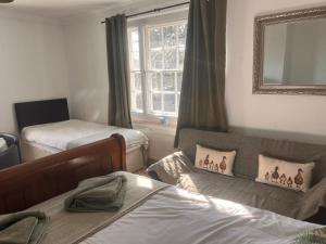 a small room with two beds and a window at Beightons Bed and Breakfast in Bury Saint Edmunds