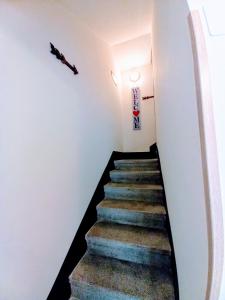 a staircase leading up to a room with white walls at Gianni's beautiful house in the mountains in Lama Di Peligni