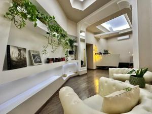 a living room with white furniture and a skylight at RomAntic Dreams Sistina Guest House in Rome