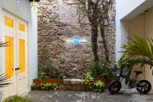 a bike parked in front of a stone wall at Casa Acomodo Casco Viejo 4bdr Historic Mansion in Panama City