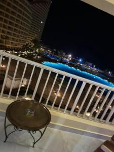 a table on a balcony with a view of the ocean at شاليهات اهرامات بورتو السخنة in Ain Sokhna