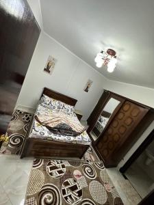 a bedroom with two beds and a mirror on the wall at شاليهات اهرامات بورتو السخنة in Ain Sokhna