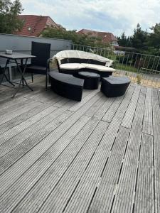 a deck with a bed and two chairs and a table at Appartment Düne 10 2OG Grundbelegung 2 Pers in Elsterheide +15 photos