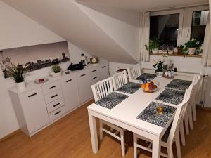 a kitchen with a white table and white cabinets at Willa Krakowia in Krzeszowice +58 photos