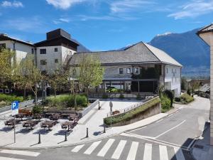 a building with tables and chairs on a street at Apartma Katarina's place in Bovec
