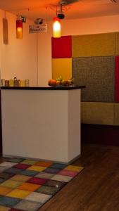 a counter with a bowl of fruit on top of it at Hotel Gifhorn INN in Gifhorn