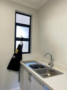 a kitchen with a sink and a window at Feels Like Home Condo Victoria Falls in Victoria Falls