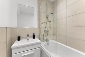 a bathroom with a white sink and a shower at Secret Abode in Harrogate in Harrogate