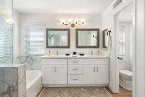 a white bathroom with a tub and a sink at Saguaro Family Fiesta in Mesa