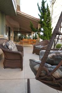 a patio with wicker chairs and a fire escape at Pousada Brisa do Mar in Torres