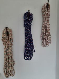 three different types of dresses hanging on a wall at FeWo Steuerbord in Malente