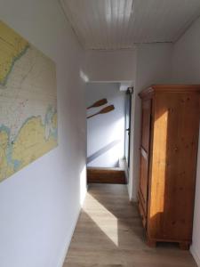 a hallway with a map on the wall and a door at FeWo Steuerbord in Malente