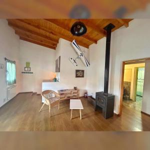 a living room with a fireplace and a stove at Buddha Tempo in Esquel