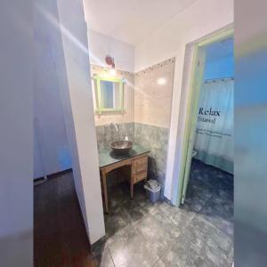 a bathroom with a sink and a counter with a mirror at Buddha Tempo in Esquel