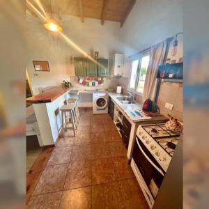 a kitchen with a sink and a stove top oven at Buddha Tempo in Esquel