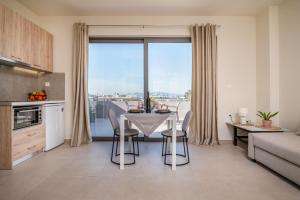 a kitchen and dining room with a table with chairs at Arangia Studio in Kos