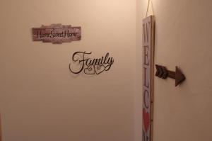 a wall with a sign that says family on it at Gianni's beautiful house in the mountains in Lama Di Peligni