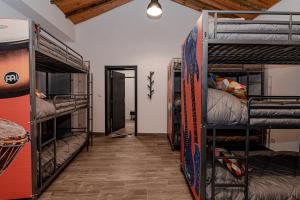 a room with three bunk beds and a hallway at Casa do Músico in Alverca