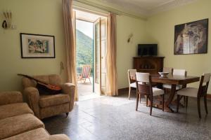 een woonkamer met een tafel en stoelen en een televisie bij Il Labirinto in Colli a Volturno