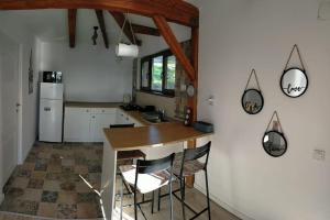 a kitchen with a counter and some chairs in it at Lake House Surduc in Fîrdea