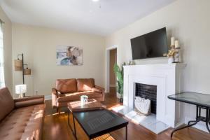 a living room with a couch and a fireplace at Backyard Beauty Bungalow in Jackson in Jackson