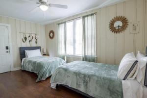 a bedroom with two beds and a ceiling fan at Backyard Beauty Bungalow in Jackson in Jackson