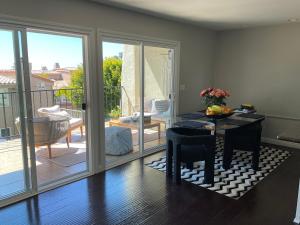 a living room with a table and a balcony at Condo in Dana Point in Dana Point