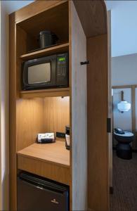a kitchen with a microwave in a cabinet at Fairfield Inn & Suites by Marriott Colorado Springs East in Colorado Springs